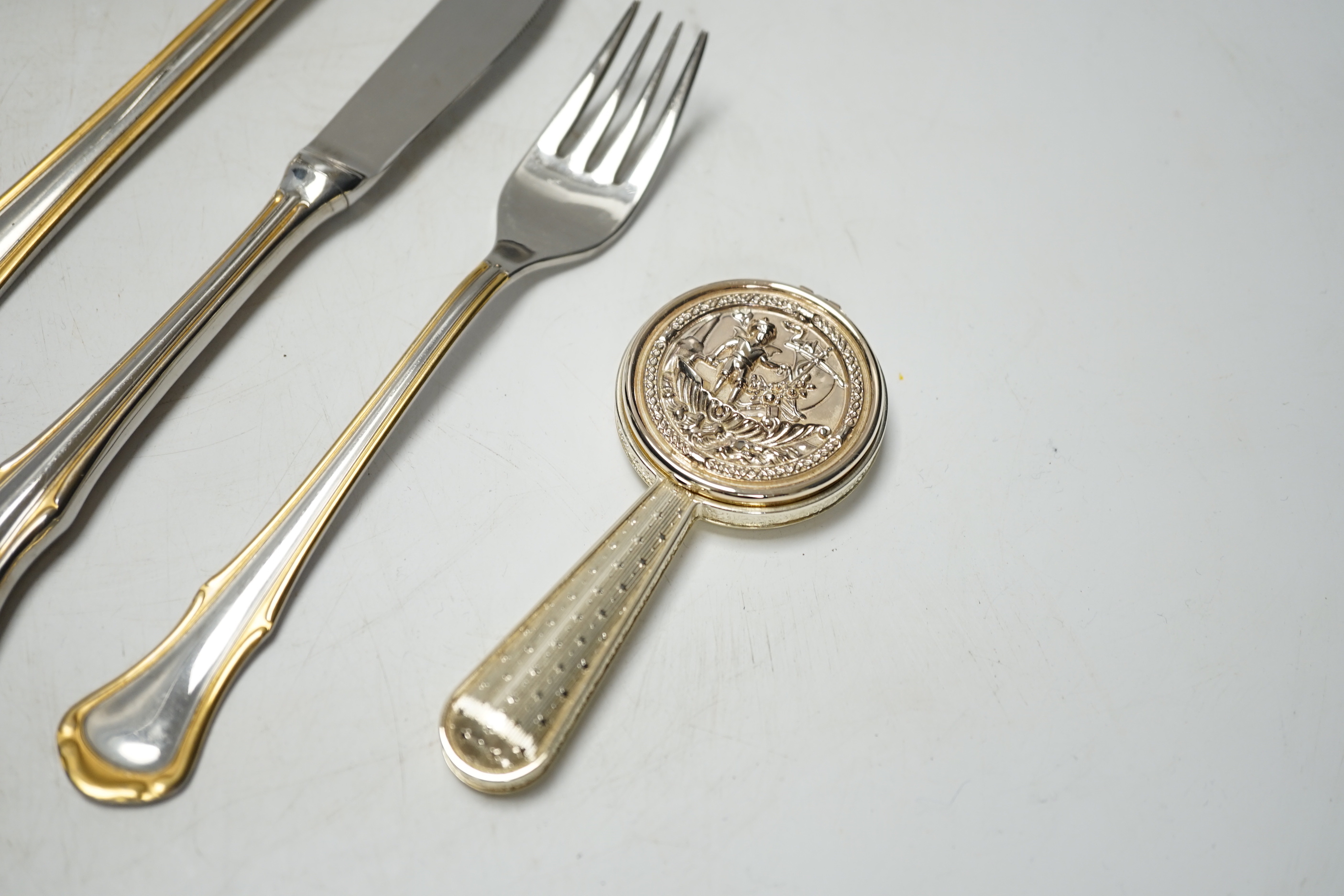 Assorted plated flatware and a pair of plated candlesticks